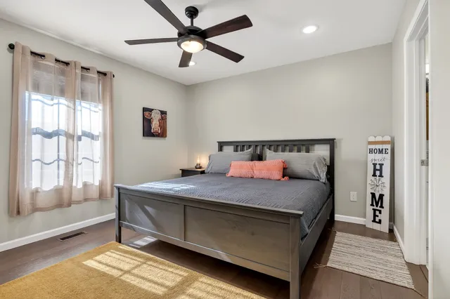 a bedroom with a bed and a large window