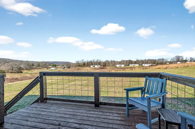 a view of roof deck with seating space and ocean view