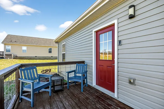 a view of a patio with table and chairs with wooden floor and fence