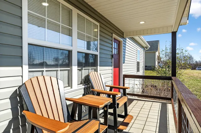 a view of balcony with wooden floor and outdoor seating