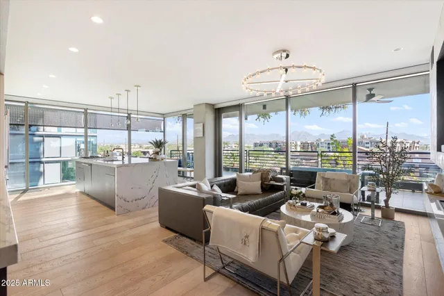 a living room with fireplace furniture and a large window