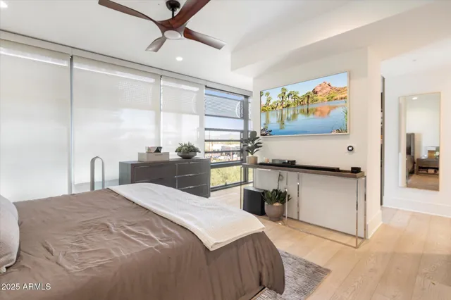 a bedroom with a large bed and a chandelier