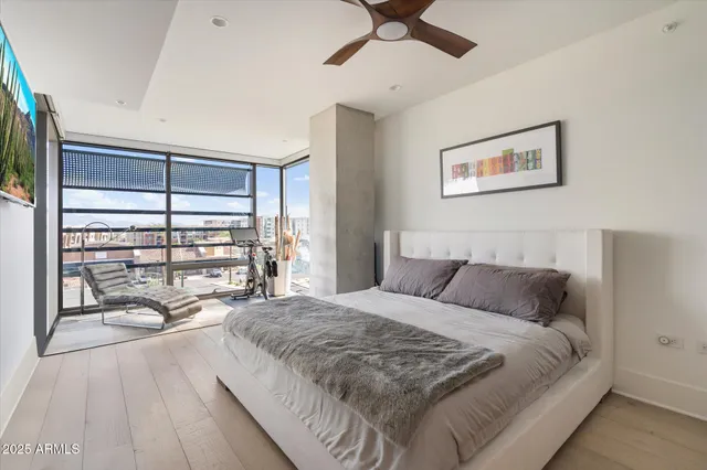 a bedroom with a large bed and a chandelier