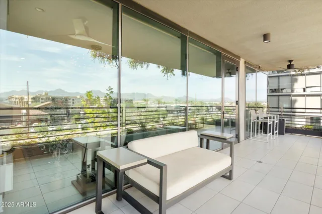 a view of a balcony with lake view and a floor to ceiling window