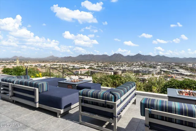 a view of a terrace with couches and lounge chairs