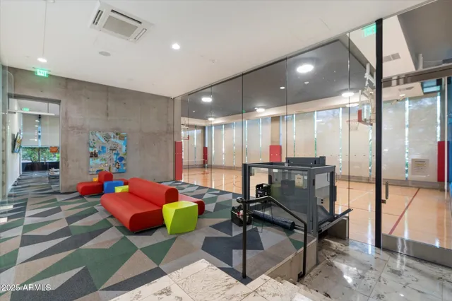 a living room with furniture and a view of kitchen