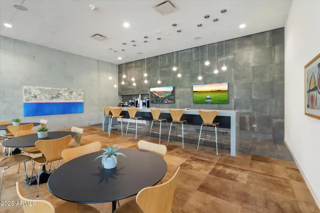 a living room with lots of furniture a rug and white walls