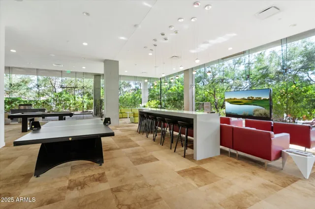 a living room with fireplace furniture and a large window