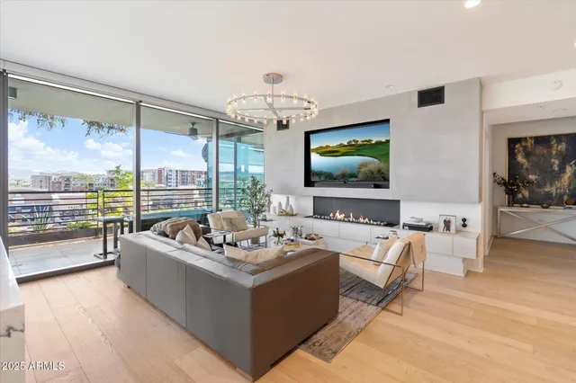 a living room with furniture large window and flat screen tv