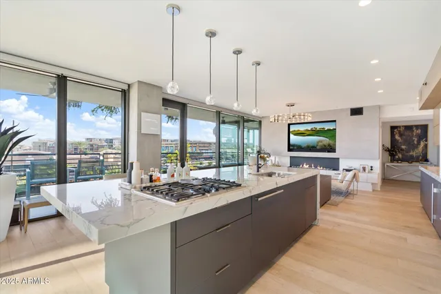 a large kitchen with kitchen island granite countertop a large window and a view of living room