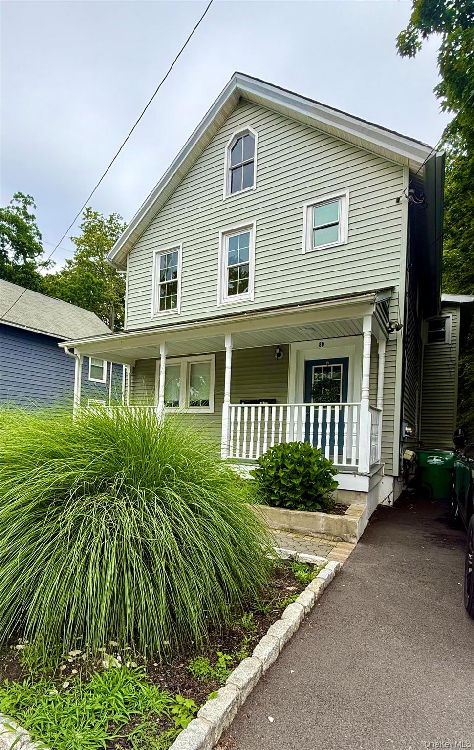 a front view of a house with a garden