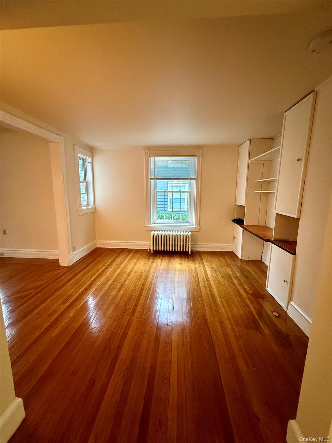 80 Teller Avenue, Unit 1 Beacon, NY 12508 - Photo 5 of 19 a view of empty room with wooden floor and fan