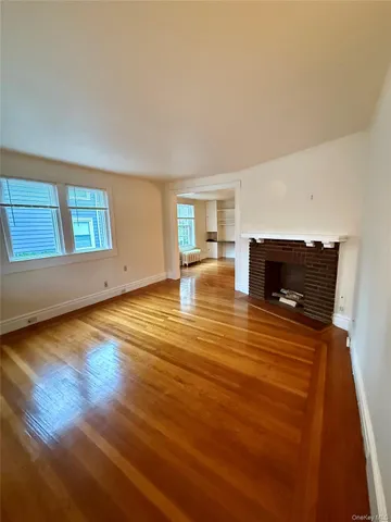 a living room with hard wood floors and a fireplace
