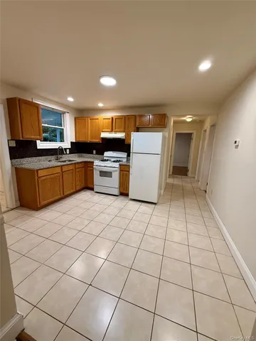 a kitchen with a sink a stove cabinets and counter space
