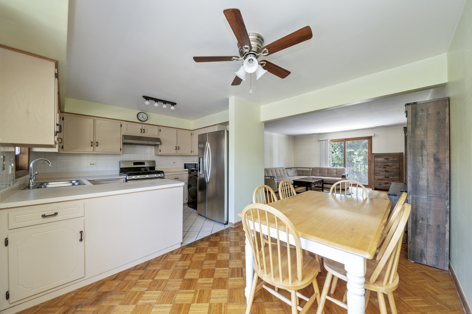 3207 North Pontiac Avenue, Unit 2S Chicago, IL 60634 - Photo 4 of 13 a kitchen with stainless steel appliances granite countertop a stove a sink dishwasher and a refrigerator with wooden floor