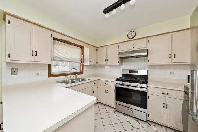 a kitchen with cabinets appliances and a sink