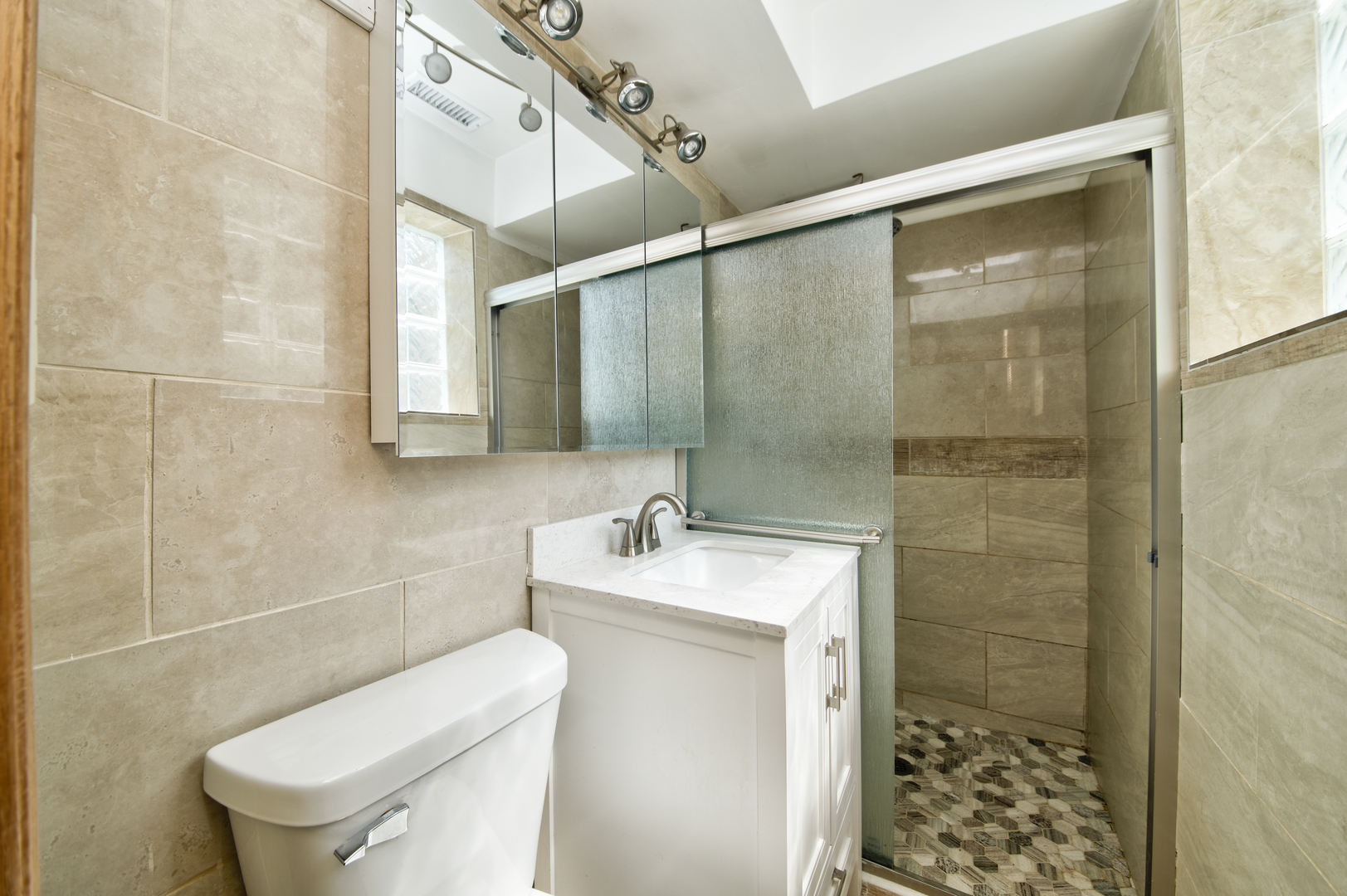 3207 North Pontiac Avenue, Unit 2S Chicago, IL 60634 - Photo 9 of 13 a bathroom with a sink toilet and shower