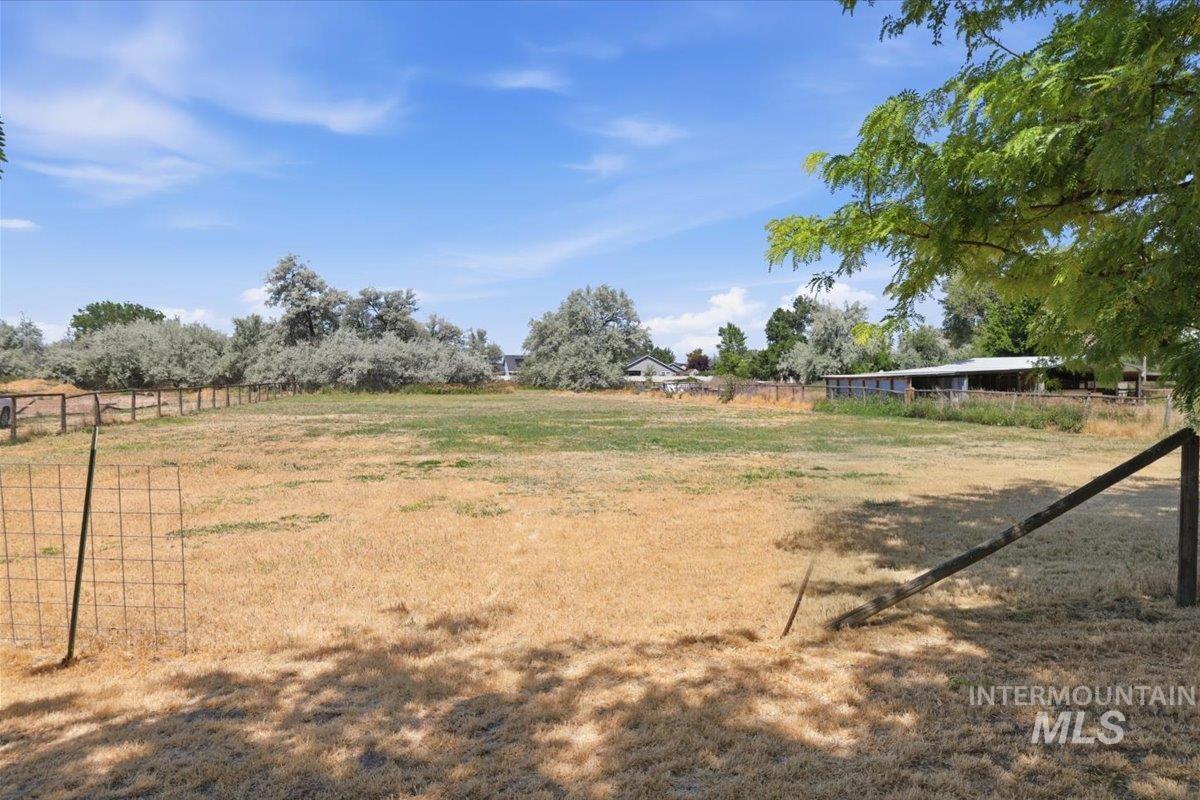 1311 North Middleton Road Nampa, ID 83651 - Photo 49 of 49 Expansive open land featuring a combination of grassy and dry areas, partial perimeter fencing, and mature trees along the property line