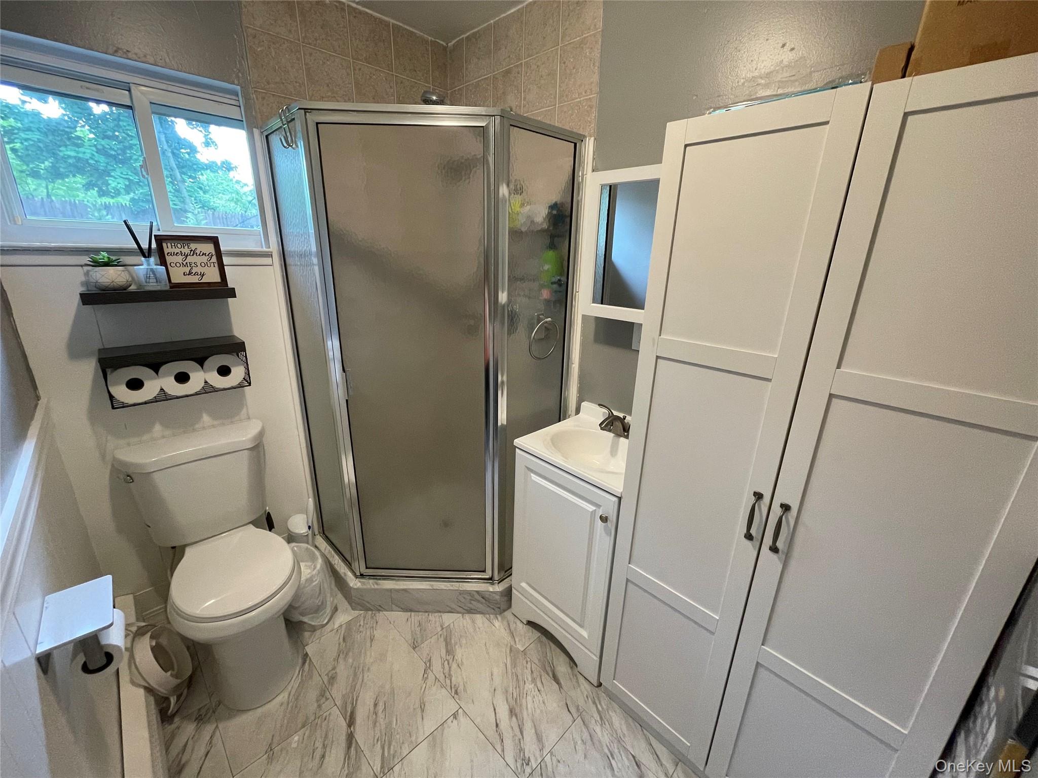 161 Hawkins Road Centereach, NY 11720 - Photo 16 of 16 a white toilet sitting next to a sink and tub
