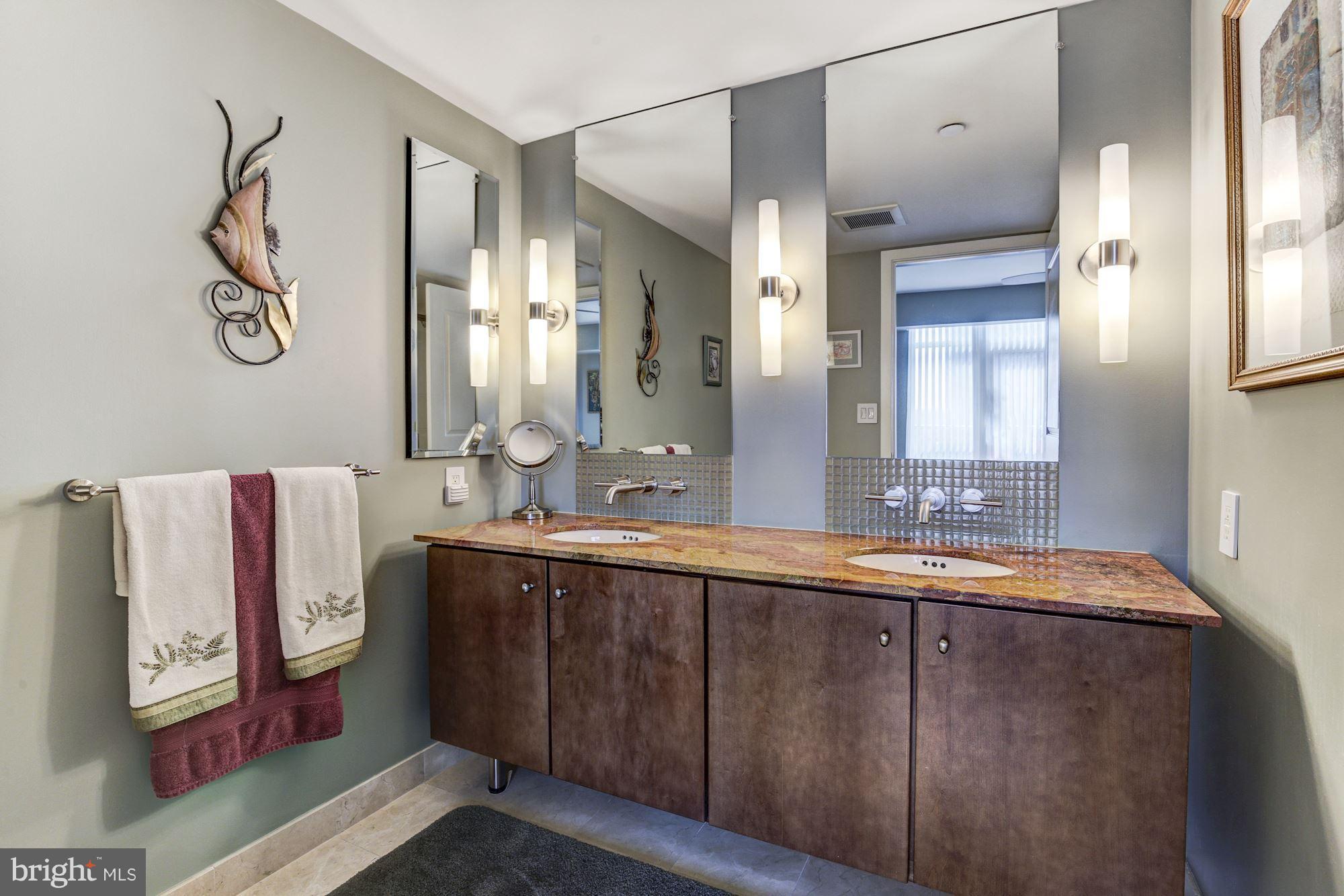 1025 First Street Southeast, Unit 613 Washington, DC 20003 - Photo 17 of 30 a spacious bathroom with a double vanity sink and a mirror