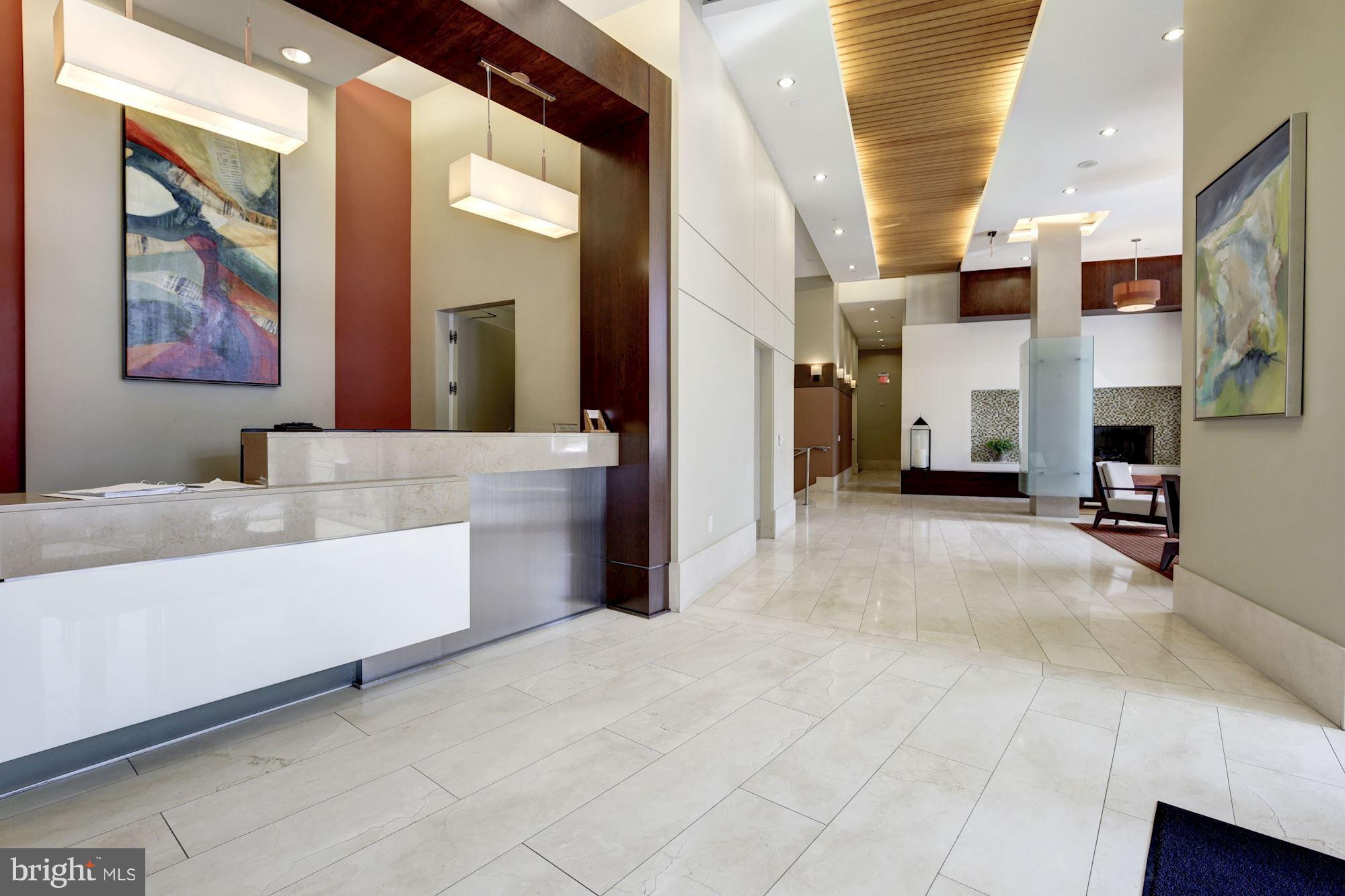 1025 First Street Southeast, Unit 613 Washington, DC 20003 - Photo 24 of 30 a living room with fireplace furniture and a chandelier