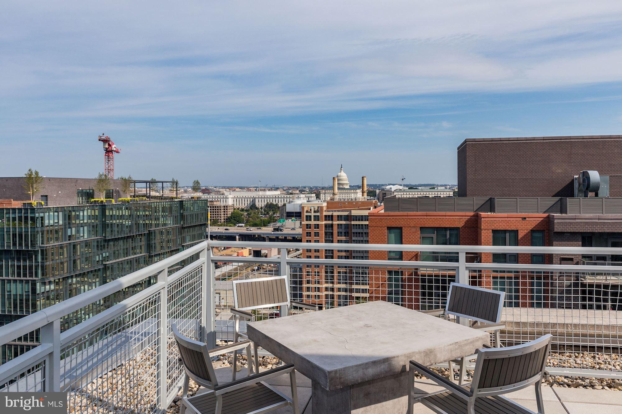 1025 First Street Southeast, Unit 613 Washington, DC 20003 - Photo 30 of 30 a view of a balcony with a table and chairs