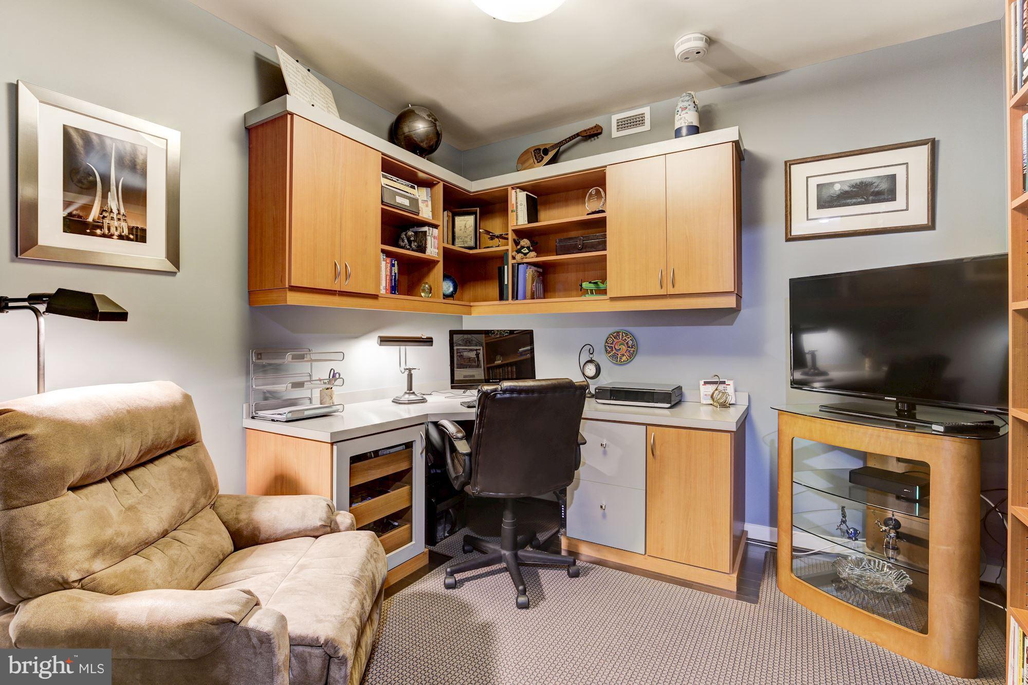 1025 First Street Southeast, Unit 613 Washington, DC 20003 - Photo 4 of 30 a view of a livingroom with workspace and a couch