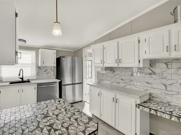 a kitchen with stainless steel appliances granite countertop a refrigerator sink and cabinets