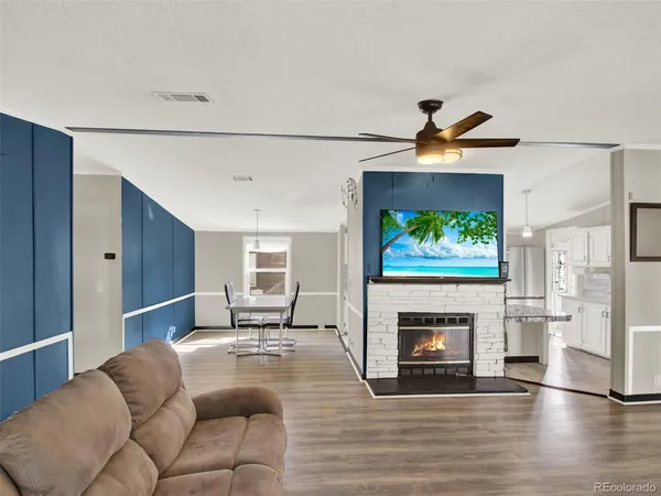 a living room with furniture and a fireplace