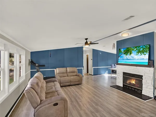 a living room with furniture and a fireplace