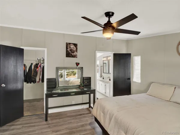 a bedroom with a bed and a ceiling fan