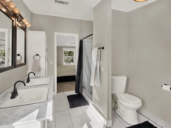 a bathroom with a sink toilet and shower