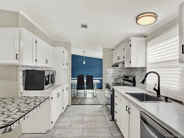 a kitchen with stainless steel appliances kitchen island granite countertop a sink and cabinets