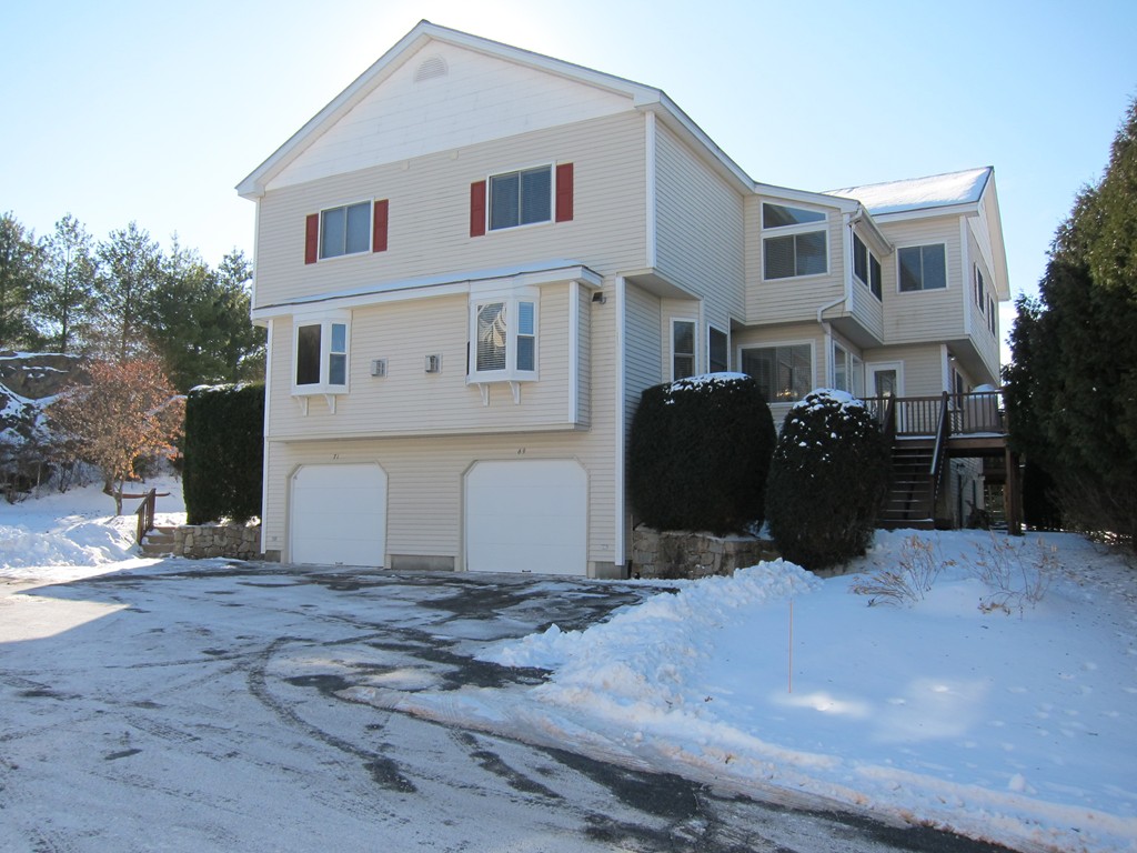 a view of a white house with large windows