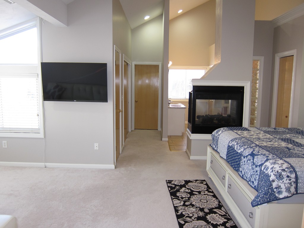 69 Half Crown Circle, Unit 69 Ashland, MA 01721 - Photo 11 of 25 a bedroom with a bed and a television