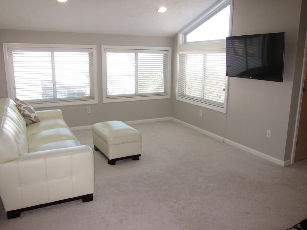 69 Half Crown Circle, Unit 69 Ashland, MA 01721 - Photo 13 of 25 a living room with furniture and a window