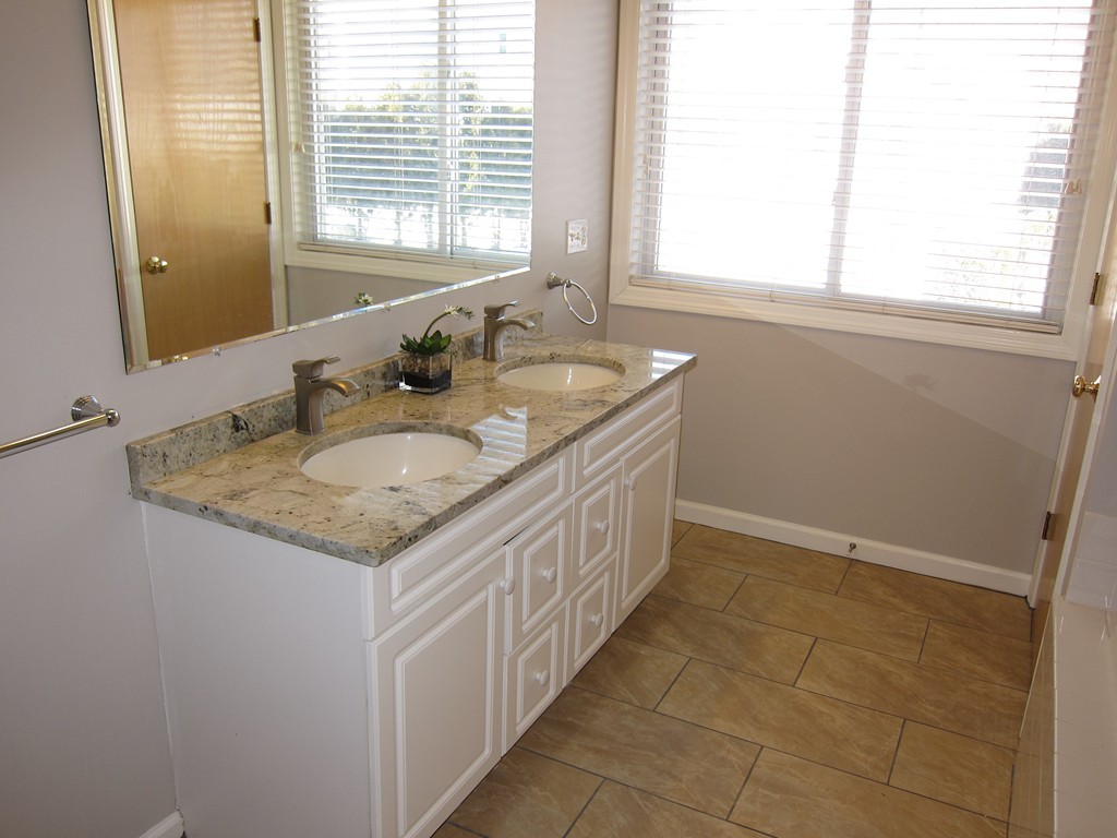69 Half Crown Circle, Unit 69 Ashland, MA 01721 - Photo 15 of 25 a bathroom with a granite countertop sink and a window