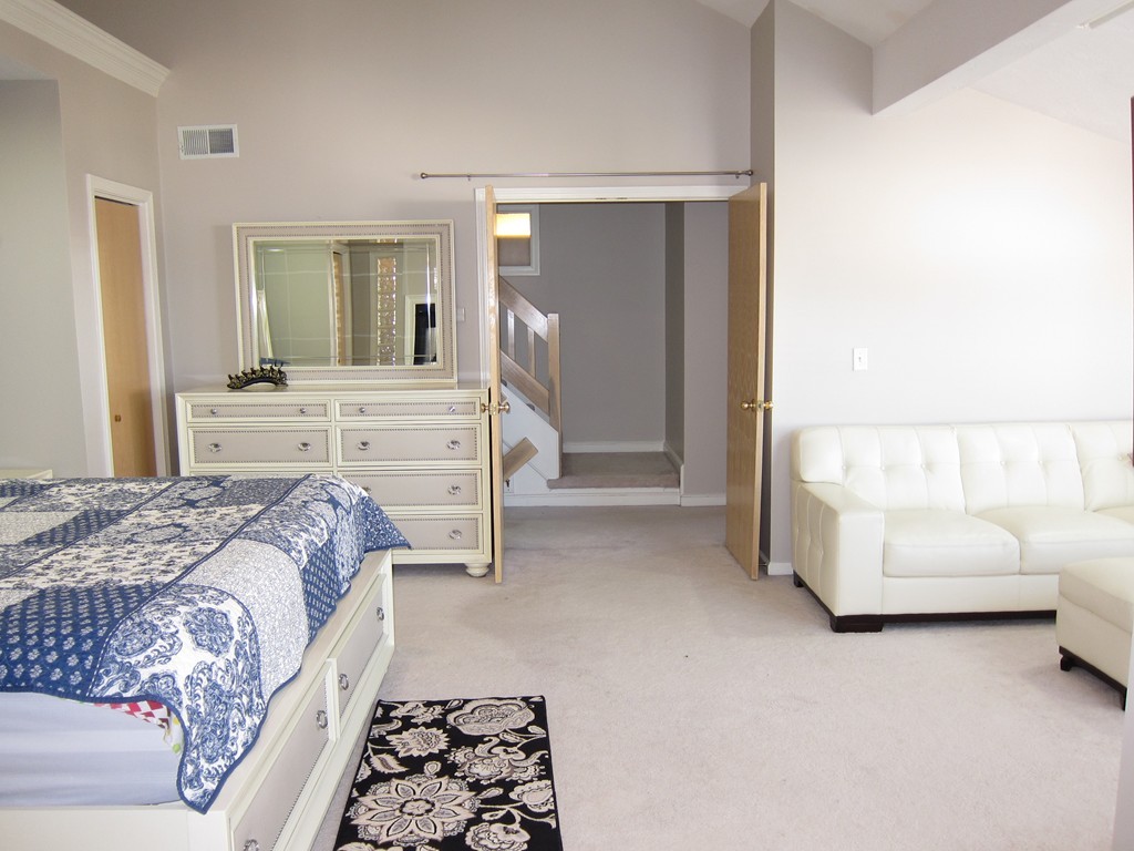 69 Half Crown Circle, Unit 69 Ashland, MA 01721 - Photo 16 of 25 a bed room with a bed and a couch