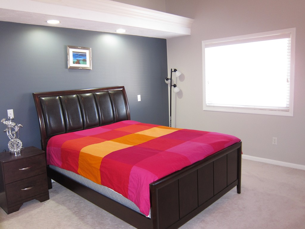 69 Half Crown Circle, Unit 69 Ashland, MA 01721 - Photo 17 of 25 a bed sitting in a bedroom next to a window