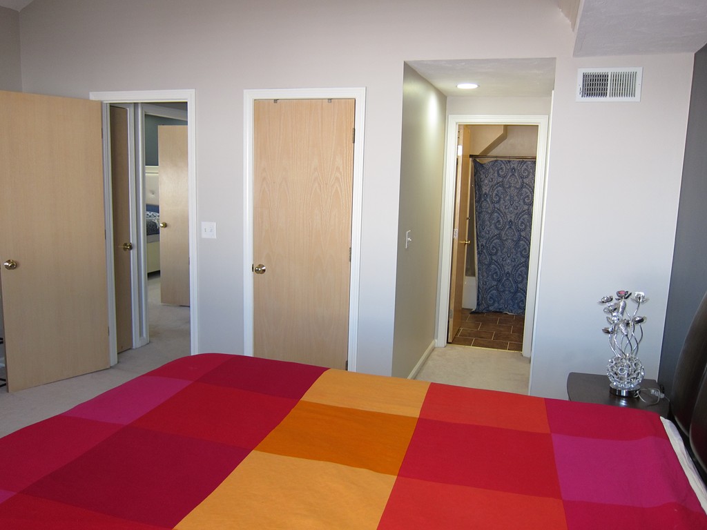 69 Half Crown Circle, Unit 69 Ashland, MA 01721 - Photo 19 of 25 a bedroom with a bed and a mirror