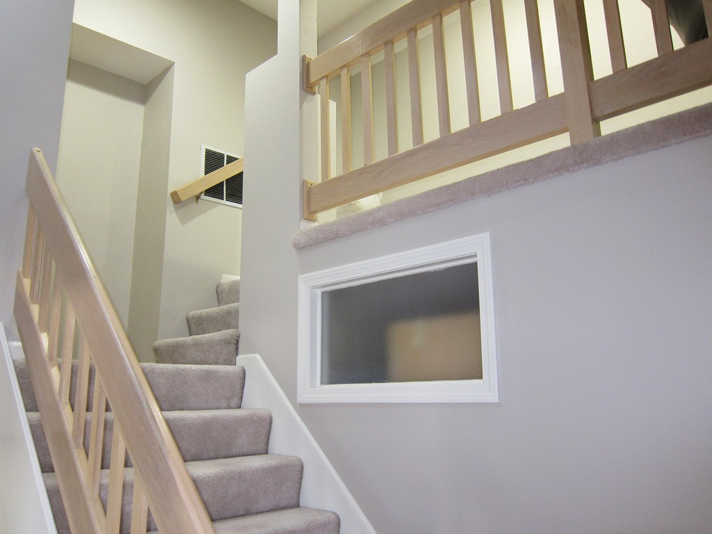 69 Half Crown Circle, Unit 69 Ashland, MA 01721 - Photo 20 of 25 a view of staircase with white walls and a window