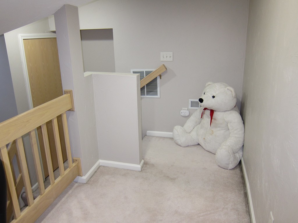 69 Half Crown Circle, Unit 69 Ashland, MA 01721 - Photo 23 of 25 a bedroom with a bed and wooden floor