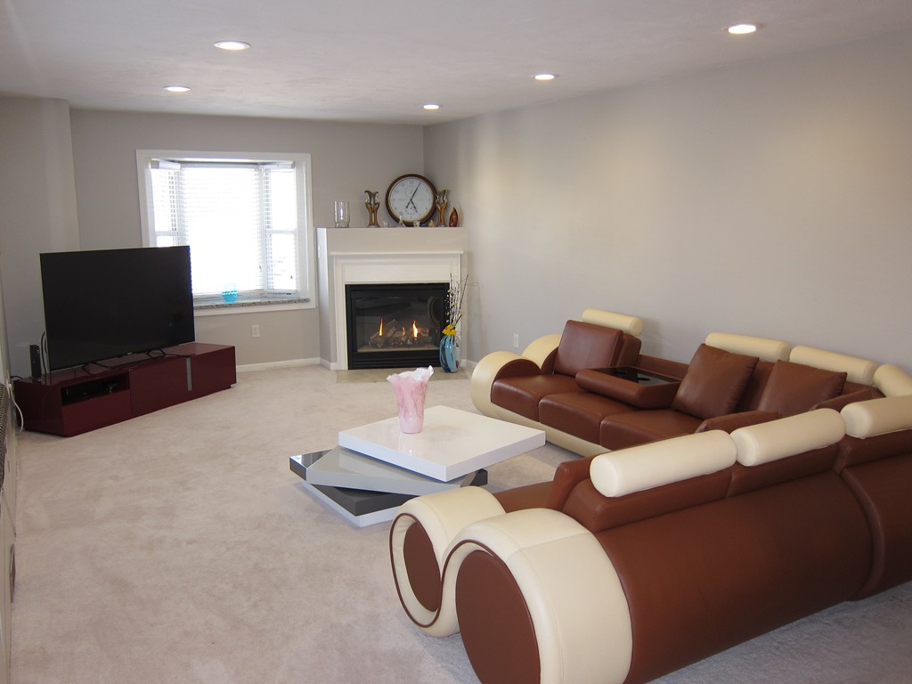69 Half Crown Circle, Unit 69 Ashland, MA 01721 - Photo 3 of 25 a living room with furniture and a flat screen tv