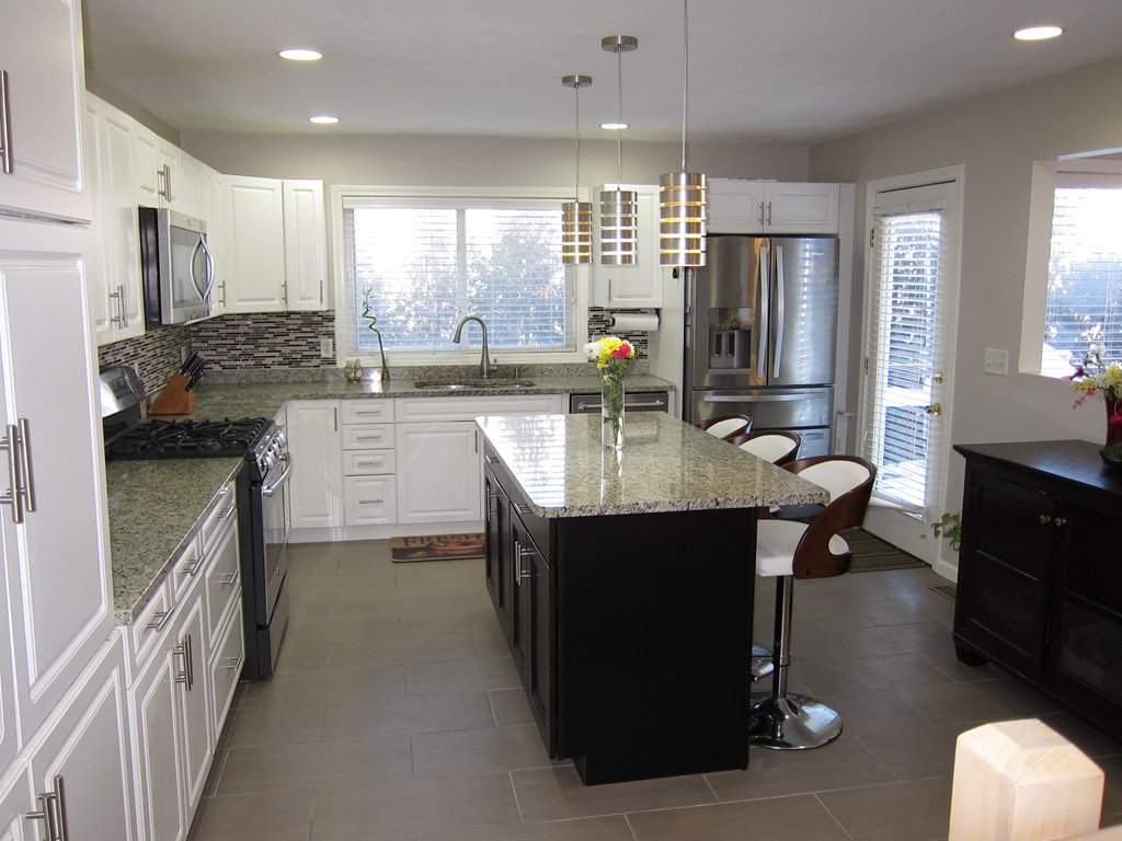 69 Half Crown Circle, Unit 69 Ashland, MA 01721 - Photo 6 of 25 a kitchen with counter top space appliances wooden floor and cabinets
