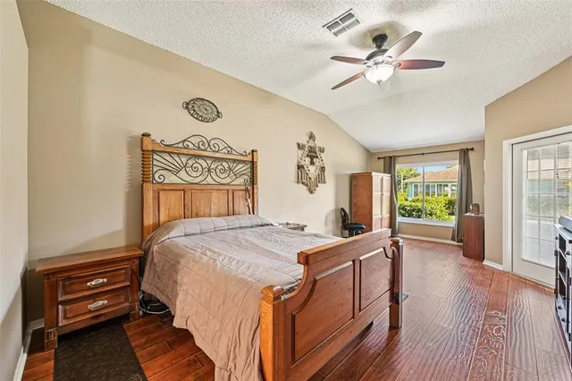a bedroom with a bed and a lamp on table