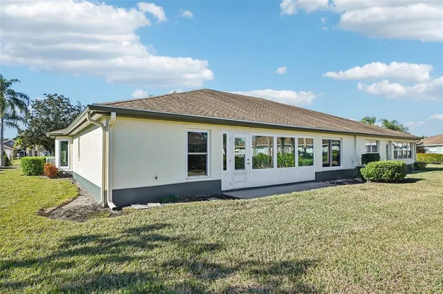 an aerial view of residential houses with outdoor space and swimming pool