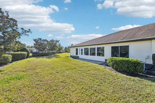an aerial view of a house with a yard and potted plants