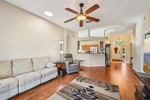 a living room with furniture a rug and a chandelier