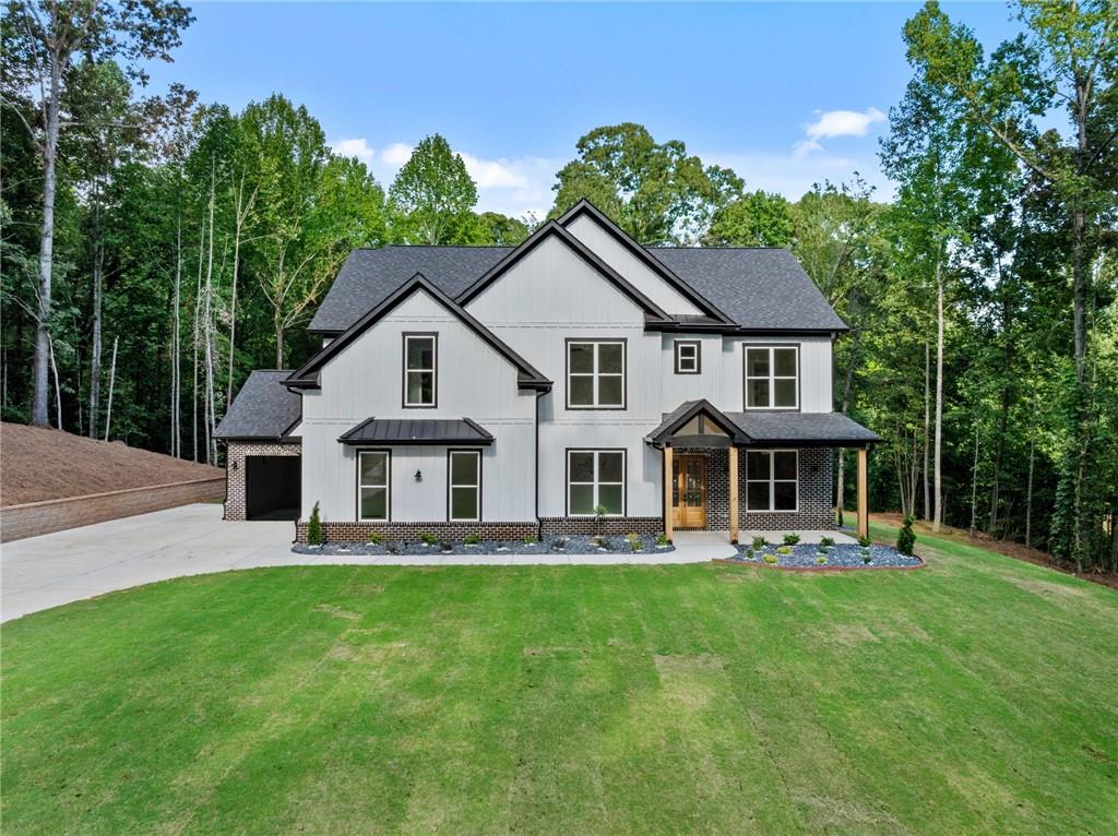 1144 Lexington Ridge Road Hoschton, GA 30548 - Photo 1 of 1 a front view of house with yard and green space