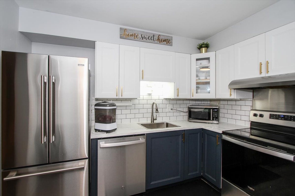 2300 Old Tavern Road, Unit 203 Lisle, IL 60532 - Photo 13 of 26 a kitchen with a refrigerator sink and cabinets